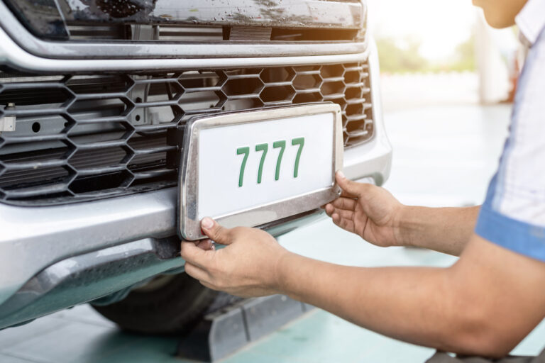 Technician changing UK car number plates in service center